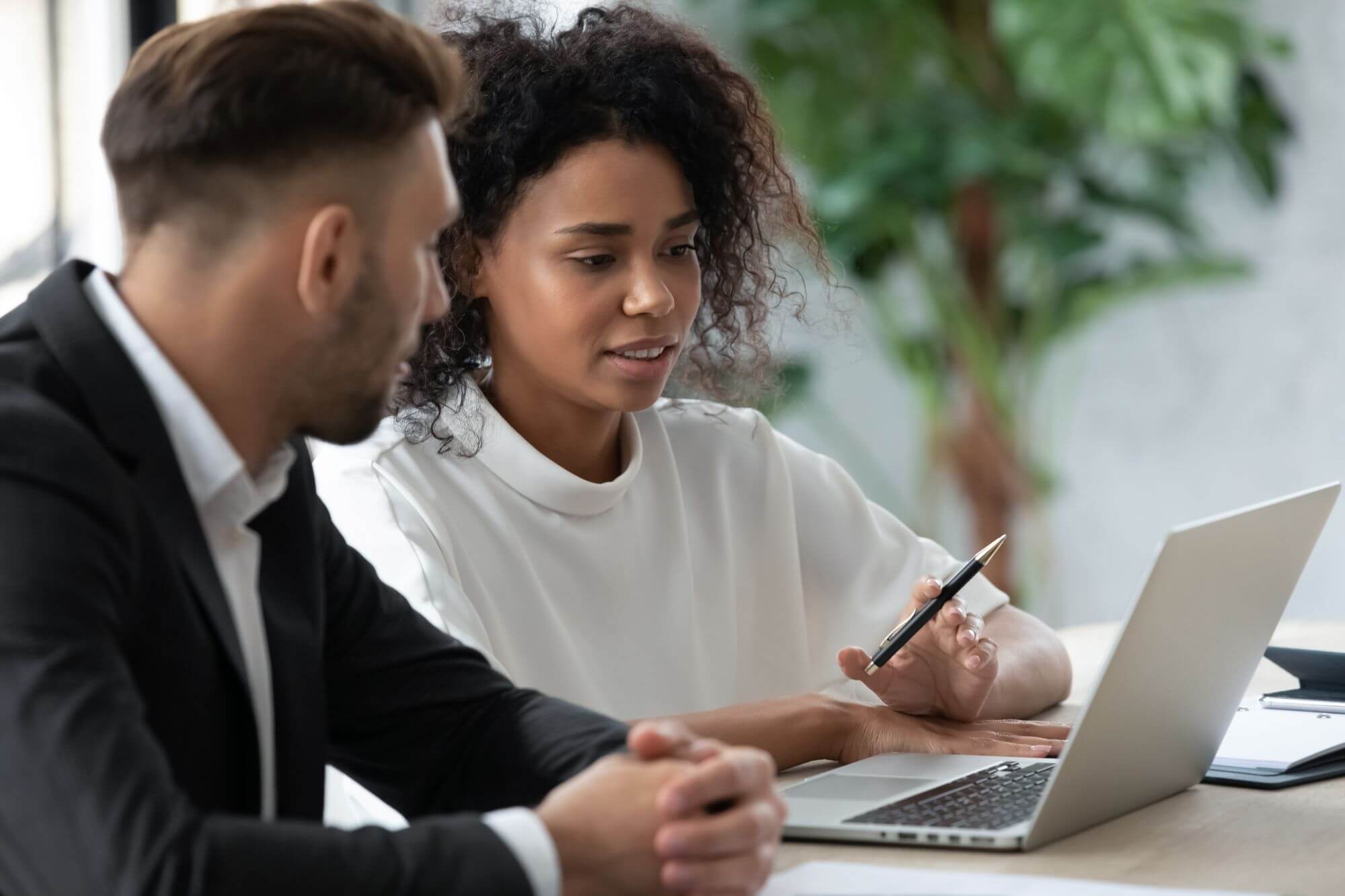 Male worker consulting female account manager